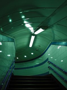 an escalator and stairs in a subway station