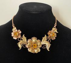 "Rose gold and yellow gold plated, topaz rhinestone floral necklace  Very good condition, vintage, late 1930-s.  Unmarked  approximately - 16 1/4\" with clasp  1 flower diameter - 1 7/8\" and 2 flowers diameter - 1 1/8\"  wt.: 2 oz.  Domestic shipping: USPS First class mail. 1-5 business days. I can file an insurance claim only after 20 business days after item was shipped International shipping: USPS First class mail. Approximately 7-21 business days. I can file an insurance claim only after 40 Gold Metal Flower Necklace For Wedding, Vintage Gold Flower Necklace For Wedding, Antique Gold Flower Jewelry, Vintage Gold Flower Necklace, Gold Flower Pendant Costume Necklace, Antique Gold Flower Necklace, Vintage Gold Metal Rhinestone Necklace, Gold Flower-shaped Costume Jewelry Necklace, Gold Flower-shaped Costume Necklace