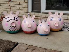 three pig sculptures are sitting on the front porch