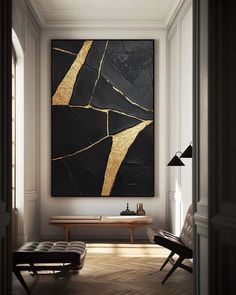 a black and gold art piece hangs above a bench in a room with white walls