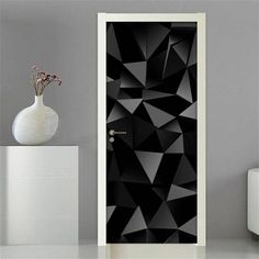 the door is decorated with black and white geometric shapes, as well as a vase full of flowers