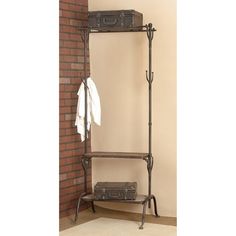 a coat rack with two suitcases on it next to a brick wall and floor