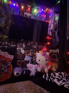 a hello kitty themed bedroom with guitars and other items on the wall, lights in the background