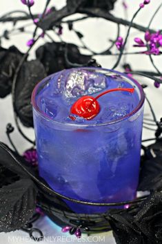 a purple drink with a cherry on the rim