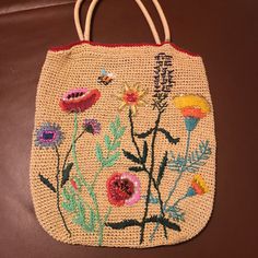 an embroidered purse with flowers on it