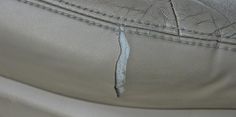 the inside of a car seat that has been stitched together with metal pins and thread