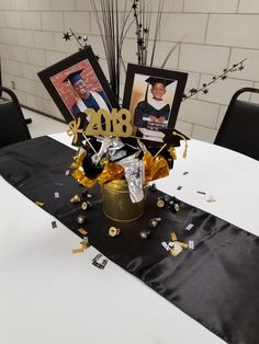 a table topped with pictures and confetti on top of a white table cloth