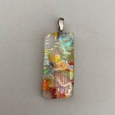 a pendant with an abstract painting on it