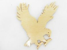 a wooden cutout of an eagle on a white background