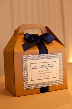 a brown box with a blue ribbon tied around it