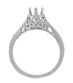 a white gold engagement ring with an intricate filigreet design on the side