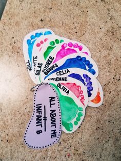 four different colored stickers with words on them sitting next to each other in front of a marble counter top