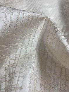 the white fabric is very soft and shiny with some lines on it's surface