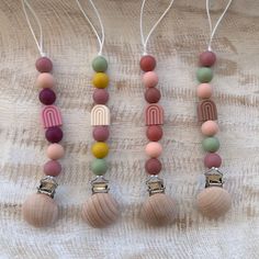 three wooden beaded necklaces on a table