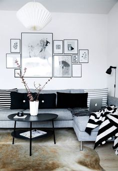 a black and white living room with pictures on the wall