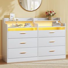 a white dresser with yellow drawers in front of a mirror