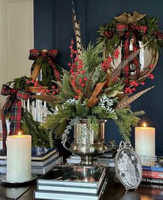 a christmas centerpiece with candles and wreaths