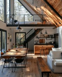 a living room filled with furniture next to a wooden floor covered in lots of windows