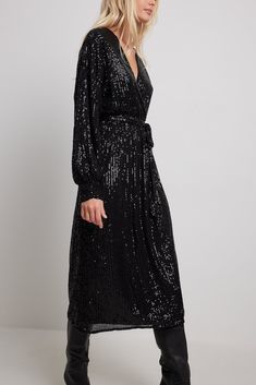 This dress features a v neckline, a wrap design, an elasticized waist with a removable self-tie band and a full lining. Wrap Dress Wedding, Sequin Material, Sequin Kimono, Black Wrap, Black Sequin Dress, Charli Xcx, Black Dresses Casual, Kimono Dress, Black Wrap Dress