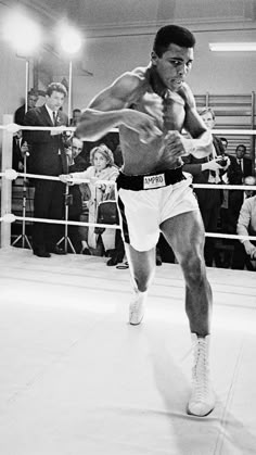 a black and white photo of a man boxing