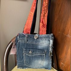 Brand New Blue Jean Baby Custom And Handmade Denim Patchwork Crossbody Bag, Made From Upcycled Jeans. Accented With A Beautiful Interior And Patterned Strap, This Bag Is A Twist On Modern Retro Style. One Of A Kind, It Is Sure To Turn Heads When You Wear It! Features An Outer Keychain Loop And A Tie Up Front Closure Flap! Blue Recycled Denim Bags, Blue Recycled Denim Shoulder Bag With Pockets, Denim Blue Shoulder Bag With Cell Phone Pocket, Keychain Loop, Upcycled Jeans, Purple Cross, Leather Clutch Wallet, Burberry Vintage, Upcycle Jeans