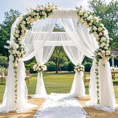 an outdoor wedding setup with white flowers and greenery