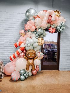 a balloon arch is decorated with candy and balloons