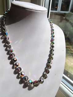 1950's Mystical Silver Aurora Borealis Glass bead Necklace, this necklace is just over 19" long with a silver tone metal screw barrel. The main bead is 1/2"inches wide and graduates either side, they glass aurora borealis beads really sparkly. This necklace is in a good condition. (26.08.24A) Vintage Beaded Crystal Necklaces, Vintage Beaded Round Crystal Necklaces, Vintage Round Beaded Crystal Necklaces, Vintage Faceted Beaded Necklace, Vintage Faceted Round Beads, Vintage Round Faceted Beads, Vintage Faceted Beaded Necklaces, Vintage Crystal Necklace With Single Strand Round Beads, Vintage Single Strand Crystal Necklace With Round Beads