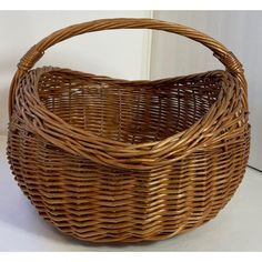 a brown wicker basket sitting on top of a white floor