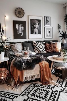 a living room filled with furniture and pictures hanging on the wall above it's coffee table