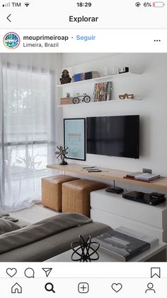 a living room filled with furniture and a flat screen tv on top of a wooden shelf