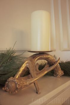 a candle is sitting on top of a mantle