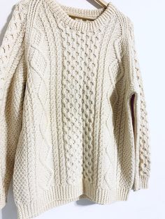 "Cream chunky knit, fisherman wool sweater with a crew neck design. This sweater is warm, definitely a fall and winter staple. Material: 100% pure wool Condition: In good vintage condition. Faint yellow stain on the right torso of the sweater. Measurements: Shoulder to shoulder: 21\" Bust: 24\" Length: 29\" Sleeve length: 23\" Estimated Size: Large Remember shipping is FREE to US IMPORTANT Pay close attention to measurements and pictures. Measurements are made with the item laying flat and are n Vintage Fisherman, Cream Jumper, Wool Pullover, Fisherman Sweater, Sweater Cream, Crew Neck Jumper, Vintage Mickey, Merino Wool Sweater, Chunky Sweater