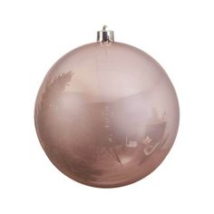 a pink ornament hanging on a white wall