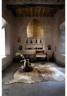 a living room with a couch, table and lamp hanging from it's ceiling