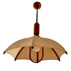 a light hanging from a ceiling fixture with an umbrella design on the top and bottom