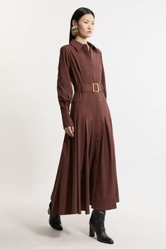 Feel Polished In Our Shirt Maxi Dress Featuring A Tailored Bodice And Pleated, Flowing Skirt. The Stylish Belted Detail Accentuates The Waist, Creating A Flattering Silhouette That Complements Every Body Type. This Maxi Dress Is An Ideal Choice For An Elevated Work Outfit And Allows You To Seamlessly Transition From Desk To Dinner With Sophistication. Formal Tailored Belted A-Line Maxi Dress Flattering Tailored Bodice Elegant Pleated Skirt Belted Detail Statement Strong Shoulders Drop Waistline Brown A-line Dress For Office, Belted Brown Dress For Work, Elegant Brown Maxi Dress For Work, Formal Brown Long Sleeve Maxi Dress, Elegant Long Sleeve Brown Shirt Dress, Elegant Brown Shirt Dress For Daywear, Formal Brown Belted Dress, Brown Long Sleeve Maxi Dress For Formal Occasions, Elegant Brown Collared Midi Dress