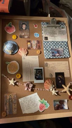 a cork board with pictures and other items on it