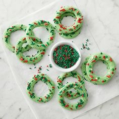 green and red sprinkles are arranged in the shape of christmas wreaths