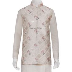 The cream waistcoat is a luxurious piece of clothing made from embroidered fabric with intricate embellishments. Its elegant design makes it perfect for special occasions. The accompanying kurta and pajama are both white and complement the waistcoat beautifully. Here are some key features of the outfit: Luxurious fabric: The waistcoat is made from high-quality embroidered fabric,giving it a rich and luxurious feel.Intricate embellishments: The waistcoat is adorned with delicate embellishments adding to its elegance and sophistication.Elegant design:The overall design of the outfit is classic and timeless, making it suitable for various formal events.Perfect for special occasions: This outfit is ideal for weddings, receptions, and other special celebrations.Comfortable and breathable: The k Prince Coat Shalwar Kameez, Designer Mehndi, Raw Silk Kurta, Black Tuxedo Suit, Waistcoat Designs, Prince Coat, Sherwani Groom, Golden Embroidery, Weddings Receptions