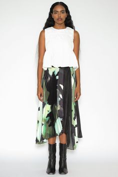 This handkerchief hem midi skirt is adorned with pleated abstract prints that add a touch of artistic flair to your ensemble. The asymmetrical line provides a modern feeling to contrast the dainty feminine prints. Crafted from a unique combination of two fabrics, the skirt features green-toned prints and see-through black silk, offering a dynamic and eye-catching look. The skirt is lined with black fabric, with an invisible zipper on the back for ease of wear. Composition: 100% Silk Mid-weight f Asymmetrical Flowy Draped Pleated Skirt, Flowy Asymmetrical Draped Skirt With Pleats, Asymmetrical Hem Pleated Skirt, Spring Flowy Draped Midi Skirt, Spring Asymmetrical Pleated Skirt With Accordion Pleats, Pleated Waist Asymmetrical Skirt For Summer, Summer Asymmetrical Skirt With Pleated Waist, Spring Midi Draped Skirt With Relaxed Fit, Asymmetrical Skirt With Pleated Waist For Summer