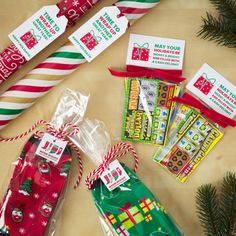 some candy wrapped in cellophane and tied up with christmas ribbon on a table