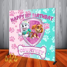 a birthday card with two dogs and paw patrol characters on it, sitting on a wooden floor