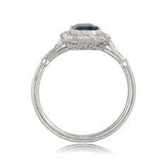 This stunning sapphire ring centers a 1.48 carat sapphire bezel set in handcrafted platinum. Surrounding the center gem is a halo of lively diamonds. This ring is further adorned by a stunning openwork filigree under-gallery and fine milgrain. ✦ DIAMOND SPECIFICATIONS: Diamond Cut: Emerald Cut Diamond Weight 1.48 Carats ✦ ENGAGEMENT RING SPECIFICATIONS: Ring Material: Platinum Stones: Diamond, Sapphire ✦ WHAT COMES IN YOUR SHIPMENT: - Your Engagement Ring - Quality Ring Box - Jewelry Cleaner - U Gia Certified Cushion Cut Sapphire Ring, Classic Gia Certified Sapphire Ring, Timeless Sapphire Ring With Bezel Setting, Classic Gia Certified Emerald Cut Sapphire Ring, Classic Sapphire Ring With Lab-created Gemstone, Elegant Baguette Cut Sapphire Ring With Bezel Setting, Round Sapphire Ring With Bezel Setting, Elegant White Gold Sapphire Ring With Bezel Setting, Gia Certified Emerald Cut Sapphire Ring In Platinum