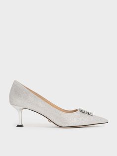 If you are trying to get your look just right for your next wedding invite, it will come easy with the help of these delightful glitter pumps. From the gem-encrusted embellishment in a square-shaped motif to the sleek metallic sculptural heel, these shoes easily deliver a modern edge to your opulent ensembles. Channel sophistication when you don these stunning pumps with a beaded bodice mini dress and complete your outfit with a sculptural clutch — now you are all set for your picture-perfect bi Silver Sequined Heels For Wedding, Elegant High Heel Wedding Shoes With Glitter Accents, Elegant Shimmer Heels For Gala, Elegant Shimmer Heels, Elegant Sequined Heels For Wedding, Elegant Glitter Accents Heels For Gala, Elegant Shimmer Heels For Formal Occasions, Elegant Shimmer Heels For Formal, Elegant Silver Glitter Wedding Shoes