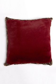 a red pillow with leopard print on the side and a brown fur trim around the edge