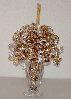 a glass vase filled with lots of different types of beads