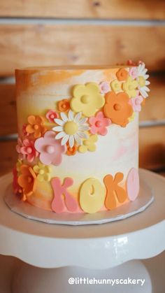 a cake decorated with flowers on top of a table