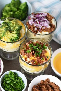 four bowls filled with different types of food on top of a table next to broccoli