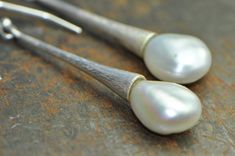 White keshi pearls are paired with a simple long silver dangle. The free form of the natural pearls contrasts beautifully with the simplicity of the silver drops, which flare at the end, as if the pearls emerge from them. The smooth, shimmering luster of the pearls also contrasts with the very textured surface of the sterling silver. I achieve the texture through hammering, and through a mix of matte and polished finishes. A minimalist design with unique details. Perfect for everyday use, a spec Sterling Silver Pear Drop Pearl Earrings, Pear-shaped Pearl Drop Earrings In Sterling Silver, Pear Shaped Pearl Drop Earrings In Sterling Silver, Elegant Hammered Teardrop Earrings, Classic Long Drop Sterling Silver Pearl Earrings, Minimalist Silver Pear-shaped Pearl Earrings, Pearl White Drop Pearl Earrings In Sterling Silver, Long Drop Sterling Silver Pearl Earrings With Charm, Elegant Hammered Teardrop Earrings For Gift